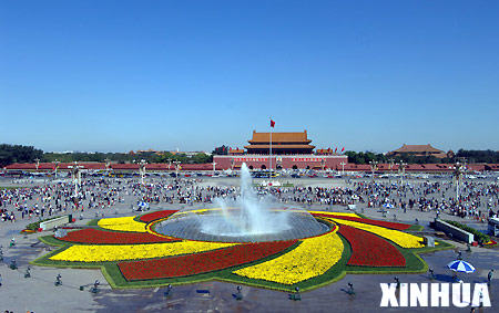 A fountain sprays in the middle of a flowerbed on the Tiananmen Square in central Beijing, capital of China, Sept. 26, 2006. Some 500,000 pots of flowers have been laid at the Tiananmen Square to welcome the Chinese National Day, which falls on Oct. 1.