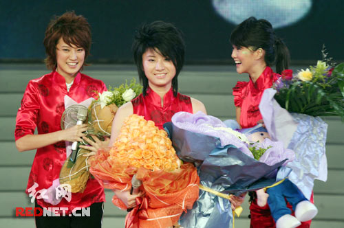 The top three winners of the popular 'American Idol'-style contest, the 'Super Voice Girl Contest' smile at the audience at the finals in Changsha, Central China's Hunan Province Friday, September 29, 2006. Shang Wenjie (C) bagged the top Super Voice Girl title while long-time favorite Tan Weiwei (R) was first runner-up. Liu Liyang (L) came in third. Nearly 500 million television viewers tuned in for the grand finale.