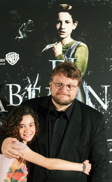 Mexican director Guillermo del Toro (R) and Spanish actress Ivana Baquero pose for the media during a photocall to promote his latest film "El Laberinto del Fauno" in Madrid October 10, 2006. 