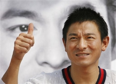 Hong Kong movie star Andy Lau flashes thumb up sign as he attends an event as part of the 11th Pusan International Film Festival in Busan, South Korea, Friday, Oct. 13, 2006. After working with veteran actor Ahn Sung-ki on the epic film 'A Battle of Wits' in China, Hong Kong movie star Andy Lau says he wants to work with his South Korean actor again, this time in his home country. Lau and Ahn, two major stars in their respective regions, praised each other during a joint appearance at the 11th Pusan International Film Festival Friday, which is honoring Lau this year as Asian filmmaker of the year.