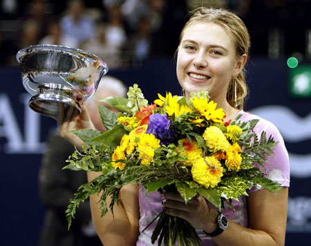 Russia's Maria Sharapova shows the winner's trophy and a bunch of flowers after winning the final match against Slovakia's Daniela Hantuchova at the WTA Zurich Open tennis tournament at the Hallenstadion in Zurich, October 22, 2006.