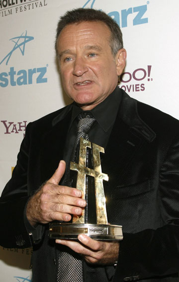 Actor Robin Williams poses backstage with the lifetime achievement award he received at the 10th Hollywood Film Festival Awards Gala in Beverly Hills October 23, 2006.