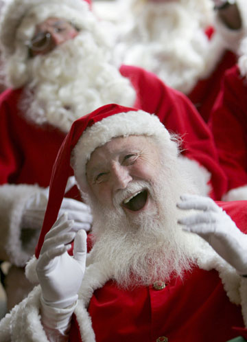 A participant at a school for Santas laughs during a day of teaching in central London October 30, 2006. The professional Father Christmases attended the annual training day on Monday before they are employed during the Christmas period.