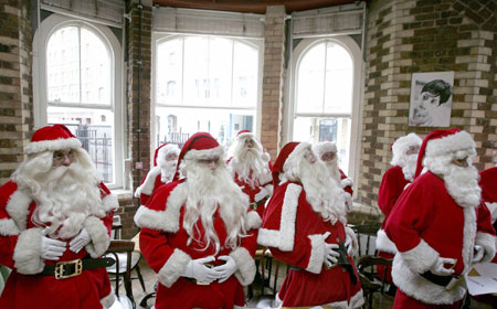 Participants at a school for Santas practice laughing during a day of teaching in central London October 30, 2006. The professional Father Christmases attended the annual training day on Monday before they are employed during the Christmas period.