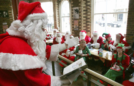 Participants at a school for Santas listen during a day of teaching in central London October 30, 2006. The professional Father Christmasses attended the annual training day, ahead of the run up to their employment over the Christmas period.
