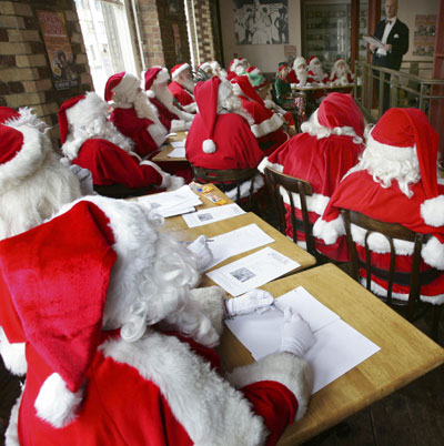 Participants at a school for Santas listen during a day of teaching in central London October 30, 2006. The professional Father Christmases attended the annual training day on Monday before they are employed during the Christmas period.