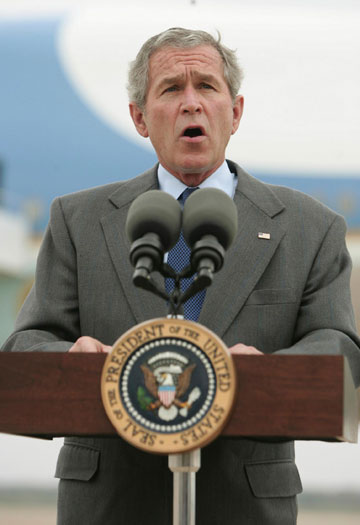 U.S. President George W. Bush speaks to the media about the Saddam Hussein trial verdict at Waco TSTC airport in Texas November 5, 2006.