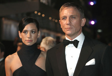 Actor Daniel Craig (R) arrives with a guest for the world premiere of the latest James Bond movie 