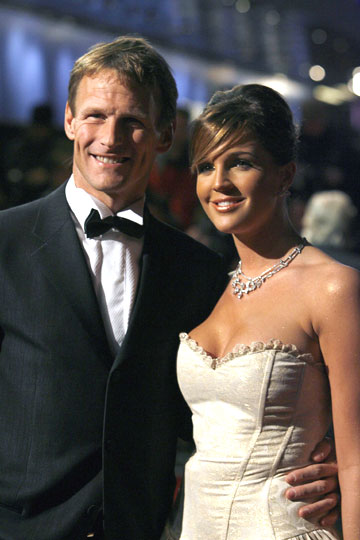 Soccer player Teddy Sheringham and his girlfriend Danielle Lloyd pose for photographers as they arrive for the world premiere of the latest James Bond movie 