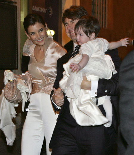 Actor Tom Cruise holds his daughter Suri as he arrives with his fiancee Katie Holmes (L) at a restaurant in Rome November 16, 2006. 