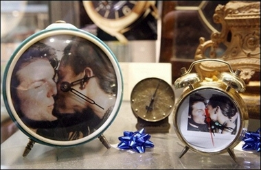 A shop sells alarm clocks with images of Hollywood star Tom Cruise and actress Katie Holmes in Bracciano, near Rome. Hundreds of fans were filling the heavily policed square below the medieval castle perched above the lakeside town of Bracciano, where Cruise is set to marry Holmes in a star-studded wedding ceremony.