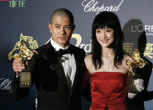Hong Kong actor Aaron Kwok and Chinese actress Zhou Xun display their trophies after winning the Best Leading Actor and Best Leading Actress awards during the 43rd Golden Horse Awards in Taipei November 25, 2006.
