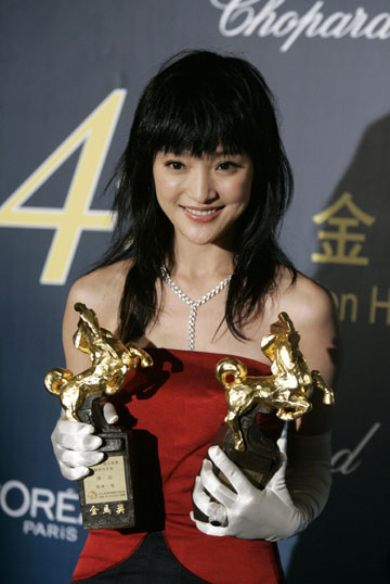 Chinese actress Zhou Xun displays the trophy after winning the Best Leading Actress award during the 43rd Golden Horse Awards in Taipei November 25, 2006.