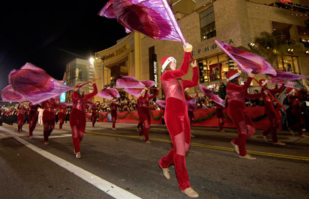 Performers wave flags during the 75th Annual Hollywood Christmas Parade in Hollywood city, California, the United States, Nov. 26, 2006.(