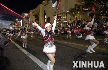 Performers wave flags during the 75th Annual Hollywood Christmas Parade in Hollywood city, California, the United States, Nov. 26, 2006.