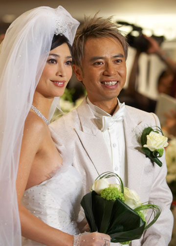Hong Kong Cantopop singer Hacken Li poses with his wife Emily Lo prior to their wedding banquet in Hong Kong November 28, 2006. 