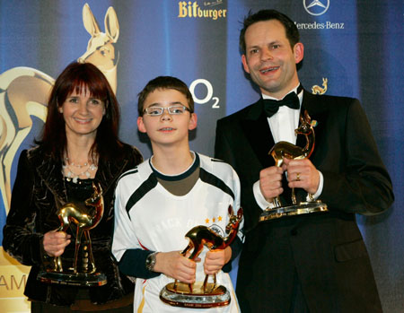 Stefanie Doerrer, Kevin Barth and Igor Wetzel (L-R) hold the Bambi award they received for social engagement during the 58th Bambi media awards ceremony in the southern German town of Stuttgart November 30, 2006. 