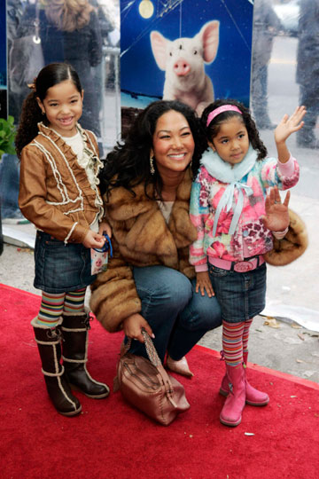 Model Kimora Lee Simmons poses for photographers with her daughters Ming Lee Simmons (L) and Aoki Lee Simmos (R) at the premiere of the film 