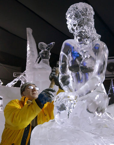 Russia's Sergey Aseev puts the finishing touch to his ice sculpture of the Little Mermaid at the fourth Snow and Ice Sculpture Festival in Eindhoven, December 7, 2006. The festival starts December 9 and lasts until January 7, 2007.