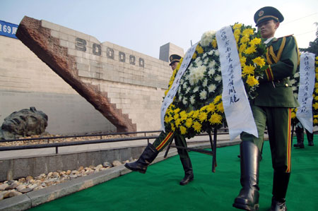 Soldiers of the Chinese People's Armed Police Force present wreaths to the victims of the Nanjing massacre during a peace rally to mark the 69th anniversary of the Nanjing massacre committed by Japanese invading troops, in Nanjing, capital of east China's Jiangsu Province, Dec. 13, 2006.