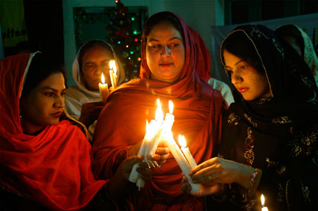Pakistani Christians light candles as they prepare for a special service, as part of Christmas celebrations, in the central city of Multan December 18, 2006.