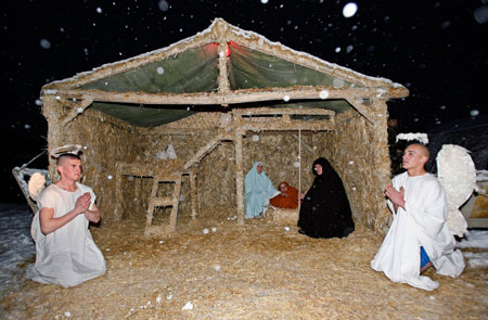 French soldiers enact the Nativity scene on Christmas Eve in Kabul December 24, 2006. Heavy snow fell across the country as thousands of foreign troops prepared to celebrate Christmas away from their families.
