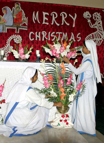 Nuns decorate a church with flowers ahead of Christmas celebrations in Dhaka December 24, 2006.