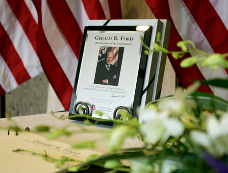 A plaque commemorating Gerald Ford sits on a table infront of a condolence book at the Gerald R. Ford Museum in Grand Rapids, Michigan, December 27, 2006. The oldest living president at 93, Ford died on December 26 of undisclosed causes at his home in California.