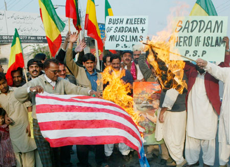 Demonstrators burn a U.S.flag to protest against the execution of former Iraqi President Saddam Hussein in Multan December 30, 2006.