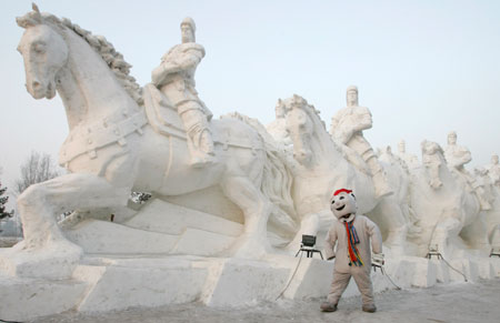 A man dressed as a snowman poses in front of a snow sculpture for the upcoming China Harbin international ice and snow festival in Harbin, northeastern China's Heilongjiang province, January 3, 2007.