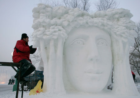 A man prepares for a snow sculpture art exhibition in the upcoming China Harbin international ice and snow festival in Harbin, northeastern China's Heilongjiang province, January 3, 2007.