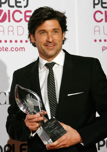 Patrick Dempsey poses backstage with his award for his role in 