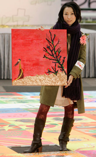 Hong Kong singer Sammi Cheng holds a painting she painted during a promotional event in Hong Kong January 21, 2007. 