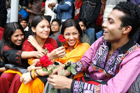 Female students of Dhaka University offer flowers to a male student in the campus during a celebration for Valentine's Day in Dhaka, February 14, 2007.
