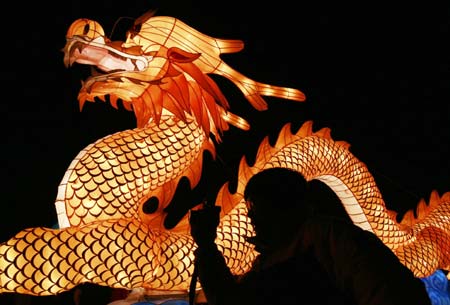 A visitor stands in front of a lantern in the shape of a dragon to celebrate Yuan Xiao Jie, or Lantern Festival, in Shenyang, Northeast China's Liaoning Province, March 3, 2007. The Lantern Festival, the last day of the Chinese Lunar New Year, falls on March 4 this year.
