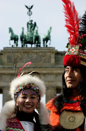 People dressed in traditional costumes from Peru (R) and Taiwan pose for photographers in front of Berlin's landmark Brandenburg Gate on the eve of the opening of the 41st international tourism industry fair (ITB), March 6, 2007.