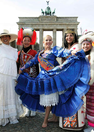 People dressed in traditional costumes from Peru (L, C and 2ndR) and Taiwan pose for photographers in front of Berlin's landmark Brandenburg Gate on the eve of the opening of the 41st international tourism industry Fair (ITB), March 6, 2007.