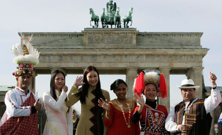 People dressed in traditional costumes of various countries pose for photographers in front of Berlin's landmark Brandenburg Gate on the eve of the opening of the 41st international tourism industry fair (ITB), March 6, 2007.