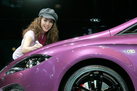 Colombian singer Shakira signs a car during a promotional event during the second media day of the 77th Geneva car show at the Palexpo in Geneva March 7, 2007.