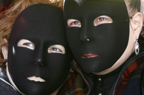 Abused women wear black masks as they protest during a rally to mark International Women's Day at Madrid's Puerta del Sol March 8, 2007. 