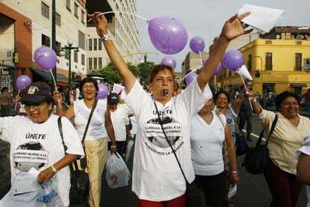 Women shout slogans protesting for women's rights during celebrations for International Women's Day in Lima,March 8, 2007. (Reuters)