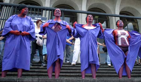 Demonstrators strip in front of the Justice Building during an International Women's Day march in Guatemala City March 8, 2007.