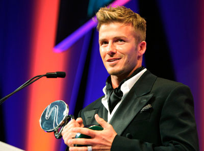 Former England captain David Beckham holds his award at the 2007 Sport Industry Awards in London March 29, 2007. Beckham won the Outstanding Contribution to British Sport accolade on Thursday.