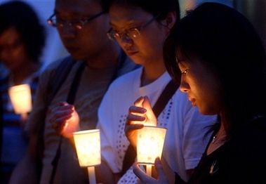 Fans take part in a candle vigil to pay tribute to the late local singer and actor Leslie Cheung in downtown Hong Kong Sunday, April 1, 2007. Cheung jumped to his death from a downtown Hong Kong hotel four years ago.