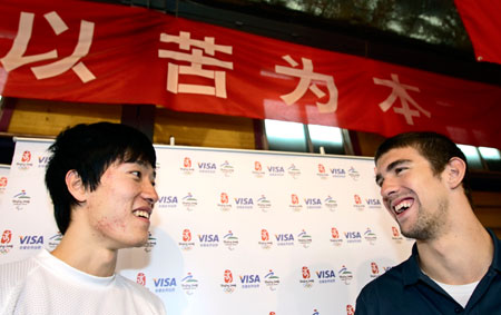 China's Olympic champion Liu Xiang (L) and America's swimming star Michael Phelps share a smile at the track and field training area of the General Administration of Sports of China in Beijing April 10, 2007. Phelps visited Liu during a visit to promote the 2007 Special Olympics, to be held in Shanghai in October.