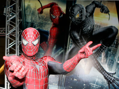 A man dressed as Spider-Man poses for photographers at the 