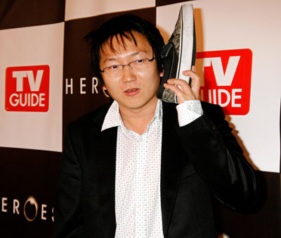 Cast member Masi Oka hold his shoe to his ear pretending it to be a 'shoe telephone' as he poses at the wrap party for season one of the NBC television series 'Heroes' in Hollywood California April 17, 2007. Oka is currently filming the movie 'Get Smart' which features a 'shoe telephone.'