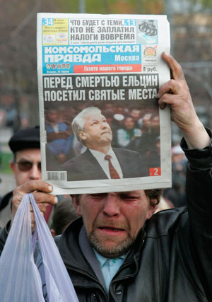 A man reacts holding a newspaper showing former Russian President Boris Yeltsin as he stands in a line at Moscow's Christ the Saviour Cathedral to pay his last respect at Yeltsin's coffin April 24, 2007. Hundreds of Russians filed past Boris Yeltsin's open coffin on Tuesday to pay their respects to the former president who dismantled the Soviet Union and led Russia in its first chaotic years of independence. The headline reads: 'Yeltsin visited holy places before his death