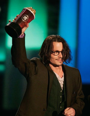 Actor Johnny Depp gestures after winning the best performance award for his role in '