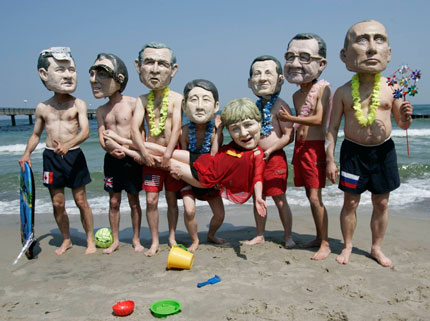 Activists of British charity organization Oxfam, wearing masks of the G8 heads of state, pose on the beach in Kuehlungsborn June 7, 2007. Leaders from the world's major industrialised nations meet in the Baltic resort of Heiligendamm on June 6-8 for a Group of Eight (G8) summit.